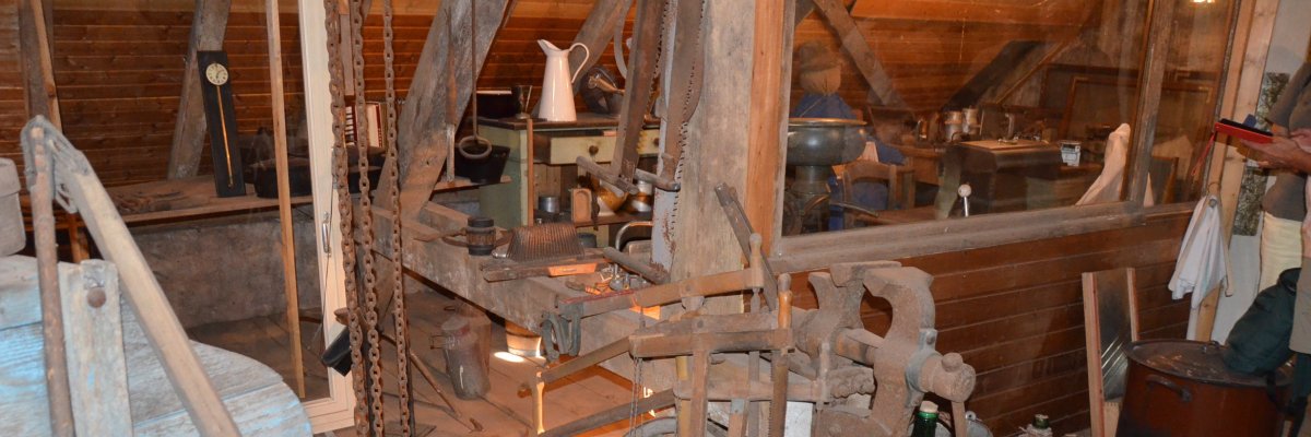 Alte Sägen, Alte Räder, Alte  Weinflaschen und alte Maschinen im Hintergrund 